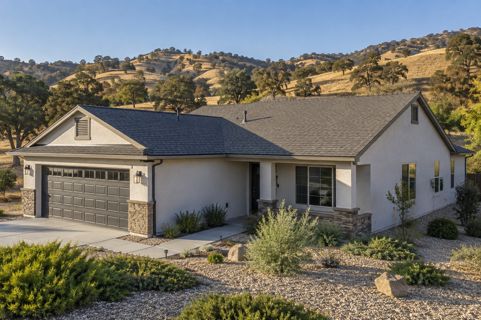 Hardened single-story home in the Sierra foothills with a Class A roof, ember-resistant gable vents and a gravel Zone 0 perimeter