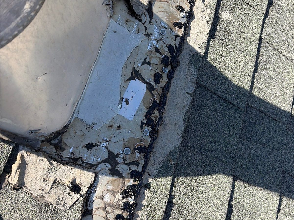 Turbine vent flashing on a Kerman roof freshly resealed with roofing cement around the fasteners and edges